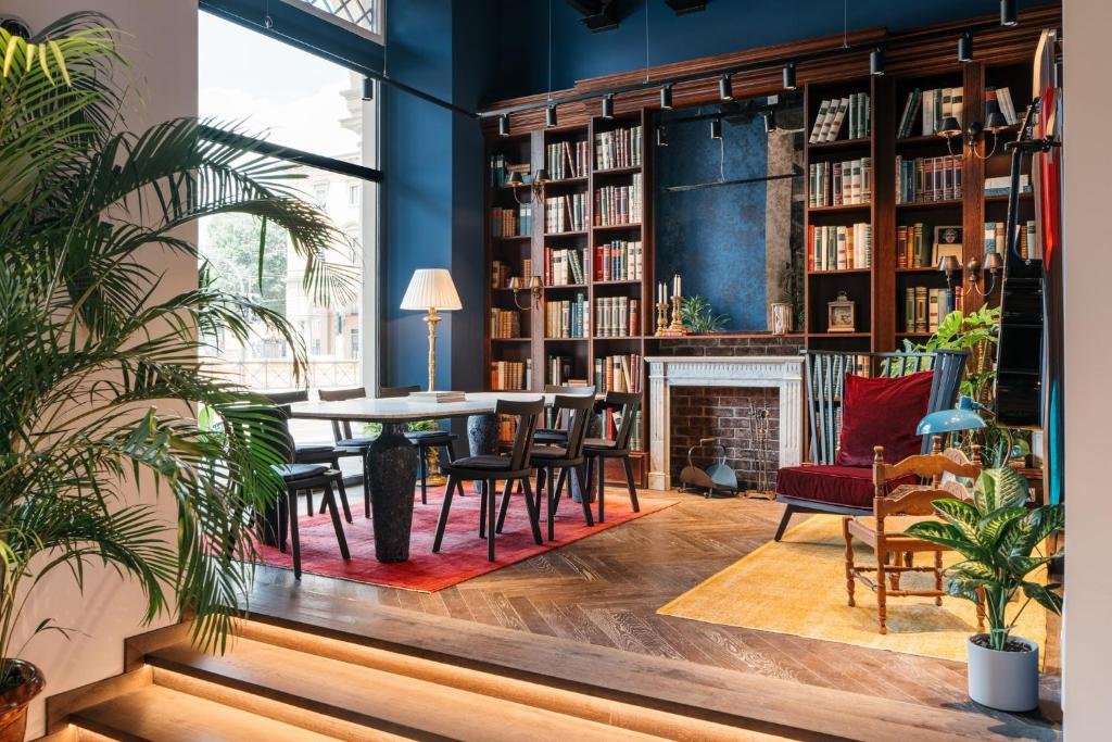 Lobby des Ruby Bea in Florenz mit Bücherwand, Kamin und Schreibtisch