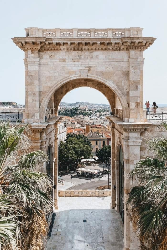 Steintor in Cagliari, Sardinien, umgeben von Palmen mit Blick auf Stadt